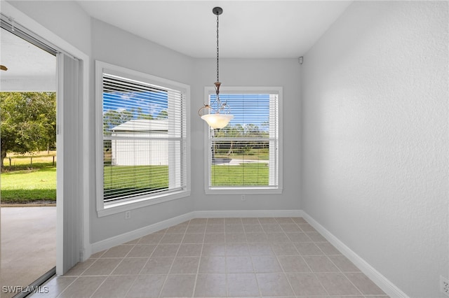 unfurnished dining area with light tile patterned flooring