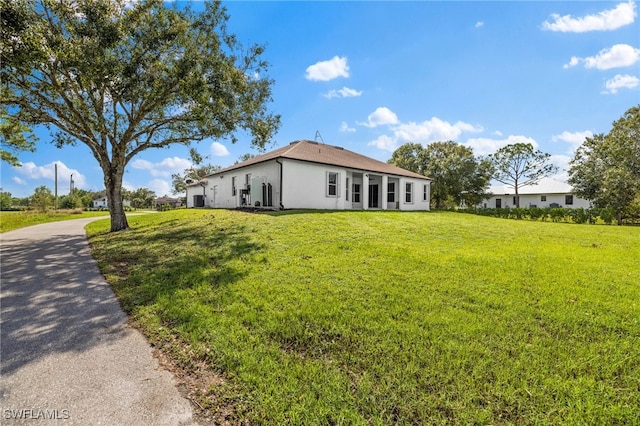 view of property exterior with a yard