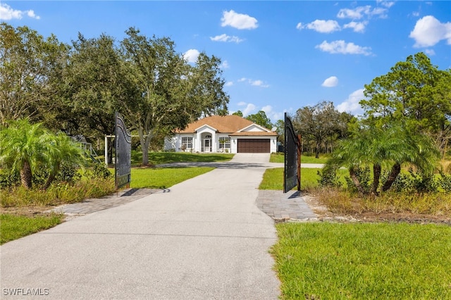 3645 70th Ave NE, Naples, FL 34120 - view of front of home featuring concrete driveway, a front yard, and an attached garage