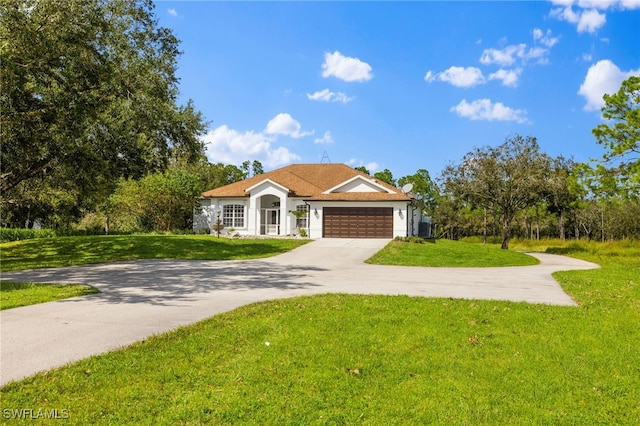 ranch-style house featuring a garage and a front lawn