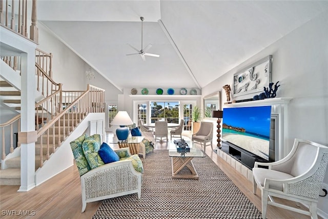 living room featuring ceiling fan, lofted ceiling, and hardwood / wood-style floors