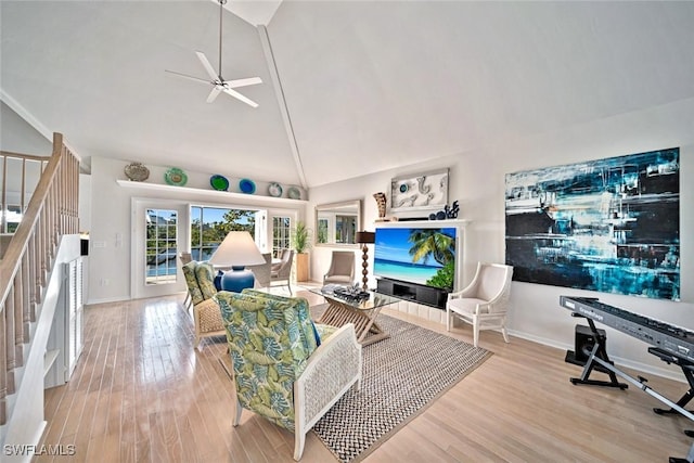 living room featuring ceiling fan, high vaulted ceiling, and light hardwood / wood-style floors