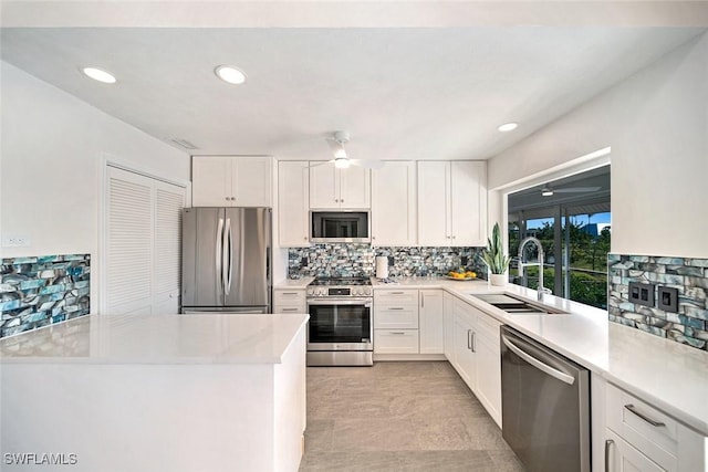 kitchen featuring sink, white cabinets, and appliances with stainless steel finishes