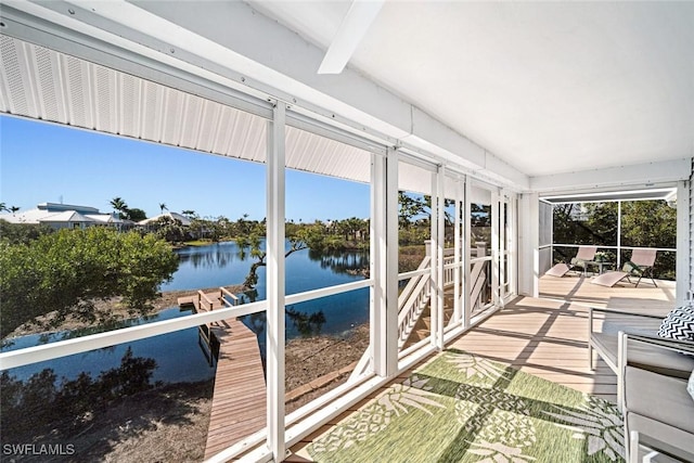 sunroom / solarium with a water view