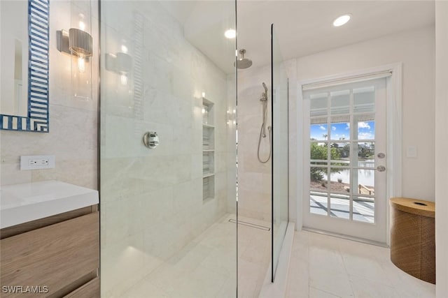 bathroom with vanity and tiled shower