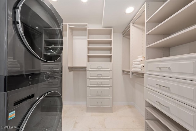 spacious closet featuring stacked washer / dryer