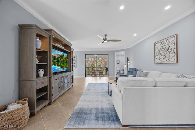 living room with ceiling fan, crown molding, and light tile patterned floors