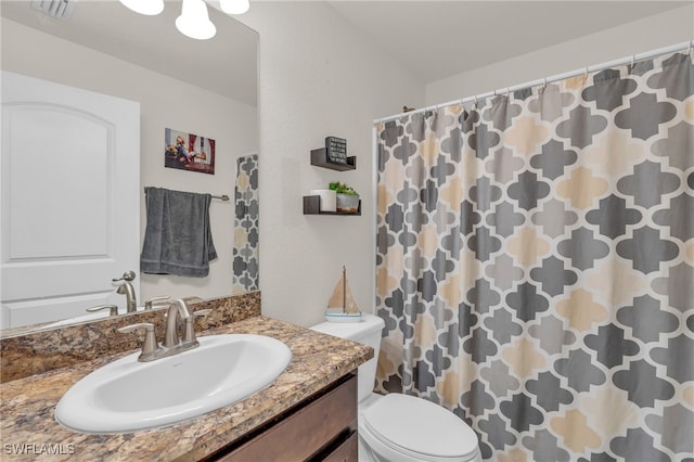 bathroom featuring vanity, toilet, and a shower with shower curtain