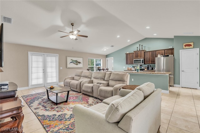 living room with french doors, ceiling fan, light tile patterned flooring, and vaulted ceiling