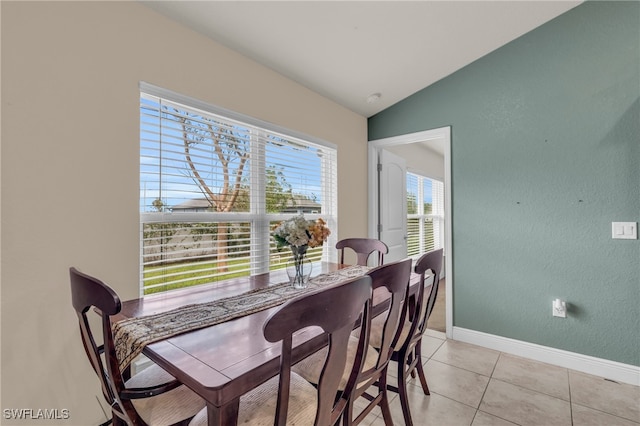 tiled dining area with vaulted ceiling and plenty of natural light