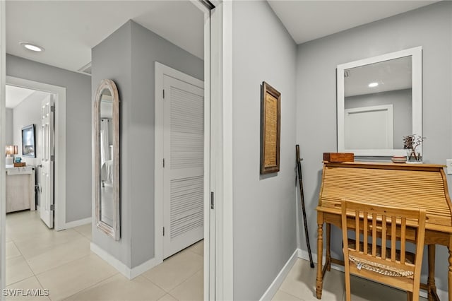 hall featuring light tile patterned flooring