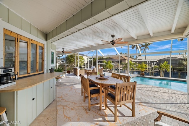 view of patio featuring a lanai