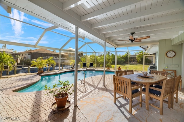 view of swimming pool featuring a lanai and a patio