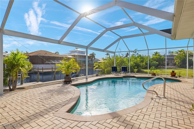 view of swimming pool featuring glass enclosure and a patio area