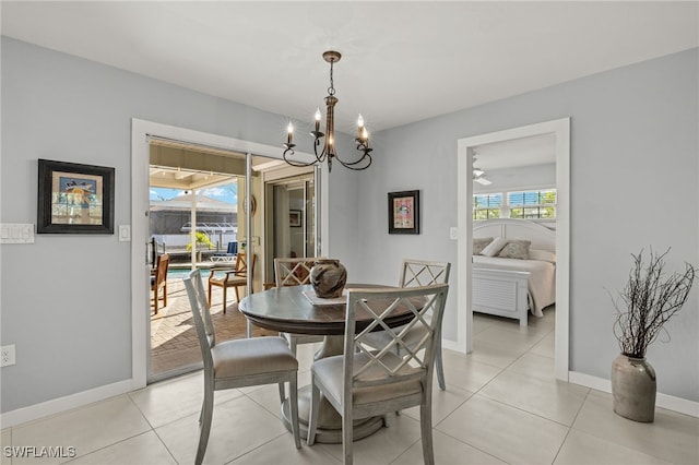 dining space with light tile patterned floors, a wealth of natural light, and a notable chandelier