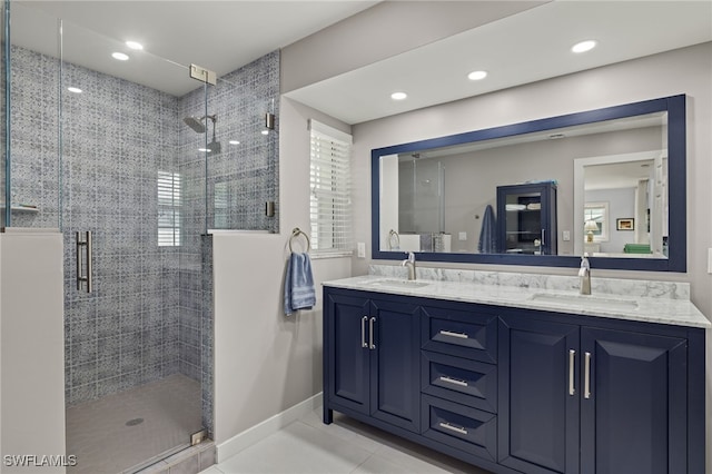 bathroom featuring tile patterned floors, vanity, and walk in shower