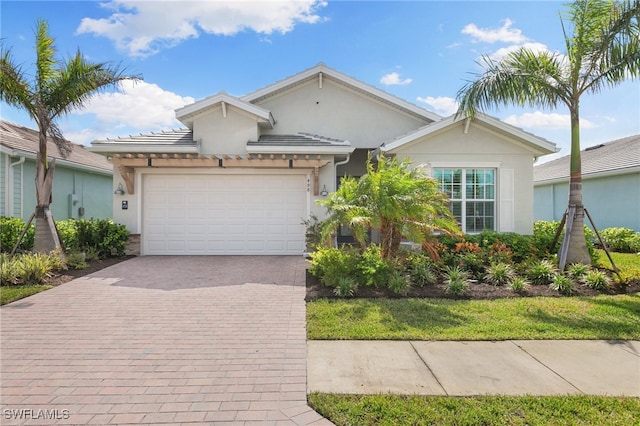 view of front of house with a garage and a front lawn