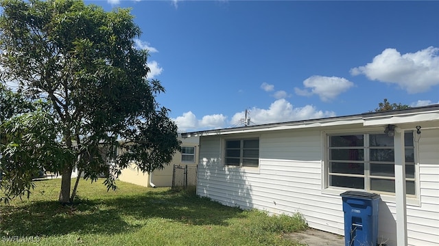 view of side of home featuring a lawn