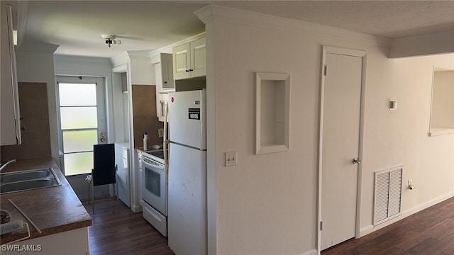 kitchen with dark wood-type flooring, white cabinets, sink, ornamental molding, and white appliances