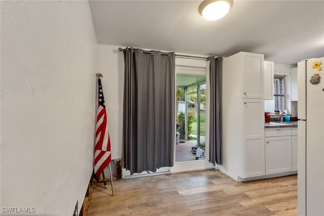 interior space with sink and light wood-type flooring