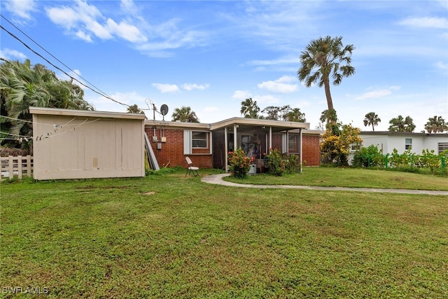 view of front of property featuring a sunroom and a front yard