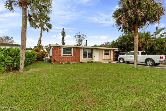 view of front of property with central air condition unit and a front lawn