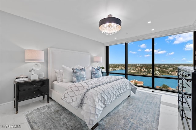 bedroom featuring a water view, floor to ceiling windows, and a notable chandelier