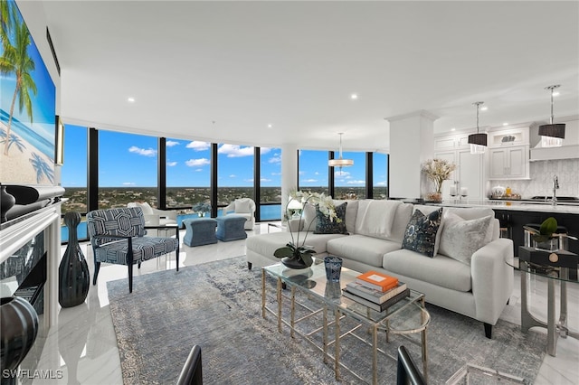 living room with sink and a wall of windows