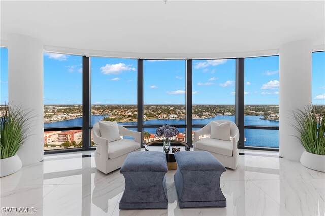 sunroom / solarium featuring a water view