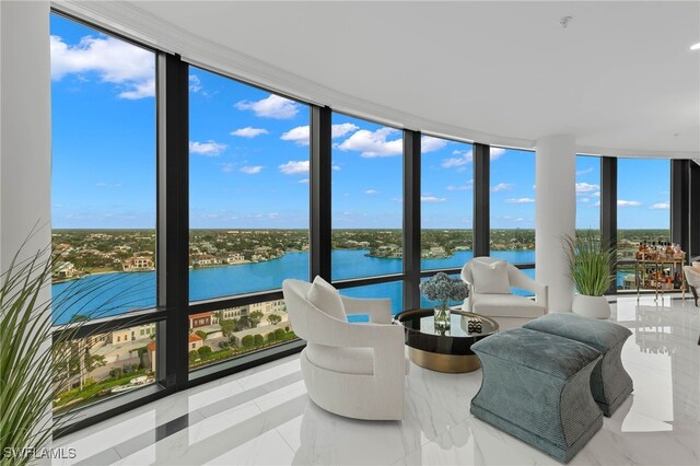 sunroom with plenty of natural light and a water view