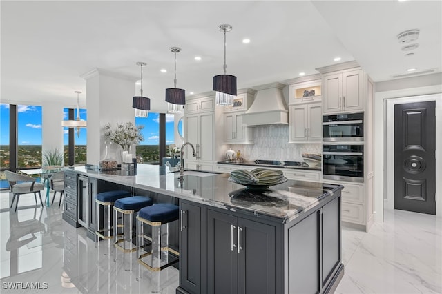 kitchen featuring pendant lighting, sink, white cabinets, decorative backsplash, and custom exhaust hood