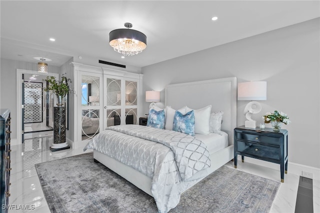 bedroom featuring a notable chandelier