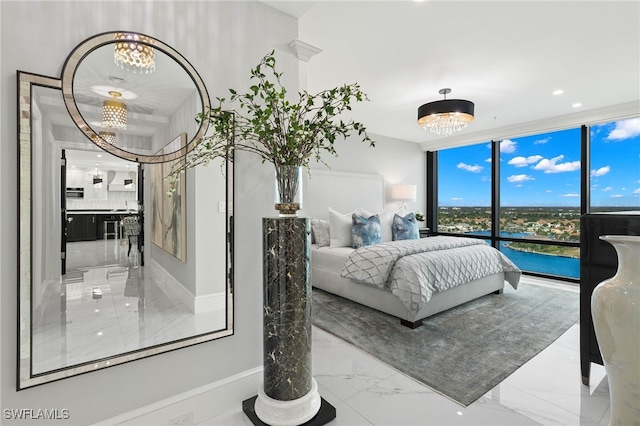 bedroom featuring floor to ceiling windows, a water view, and a chandelier