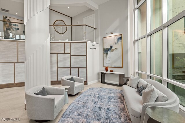 3971 Gulf Shore Blvd N Unit 1505, Naples, FL 34103 - living area featuring a towering ceiling and baseboards