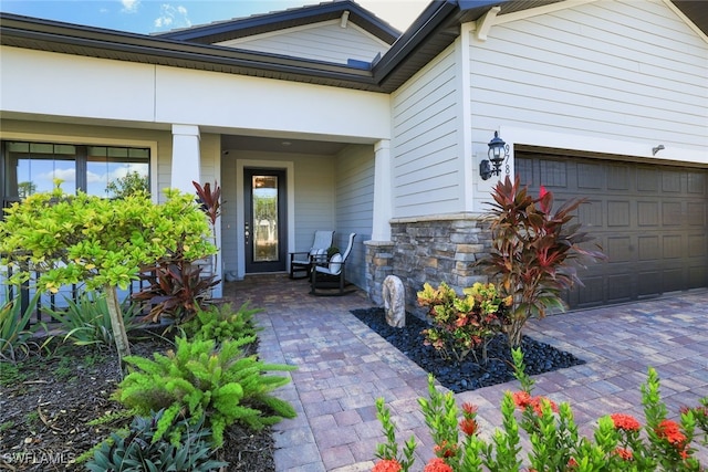 doorway to property with a garage