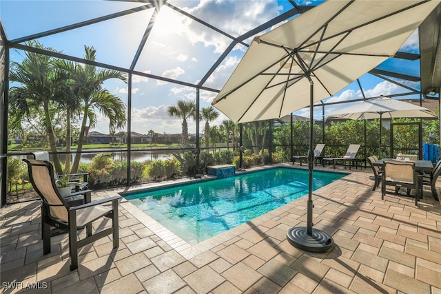 view of swimming pool featuring a water view, glass enclosure, and a patio