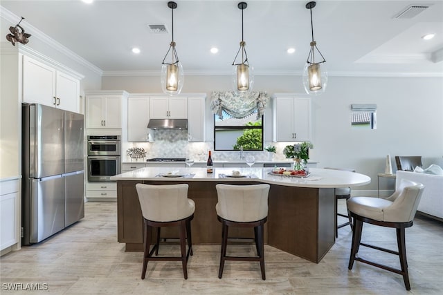 kitchen with white cabinets, stainless steel appliances, and a kitchen island