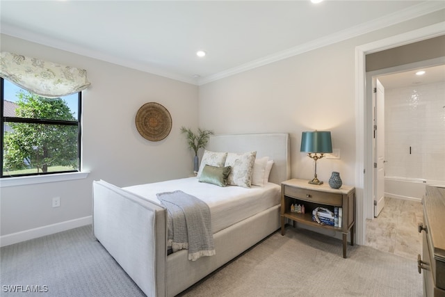 carpeted bedroom featuring crown molding and ensuite bathroom