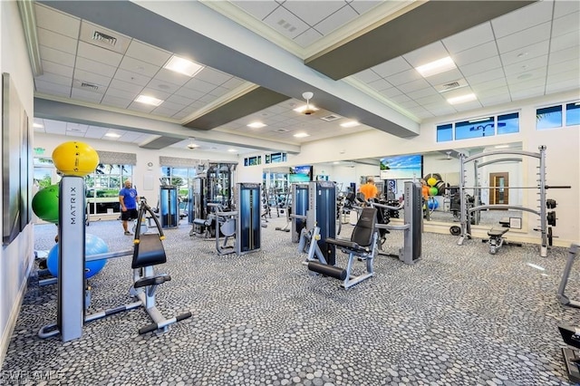 exercise room with crown molding and a drop ceiling