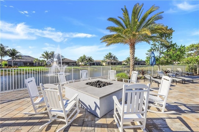 view of patio / terrace featuring a water view and an outdoor fire pit