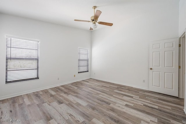 spare room with light wood-type flooring and ceiling fan