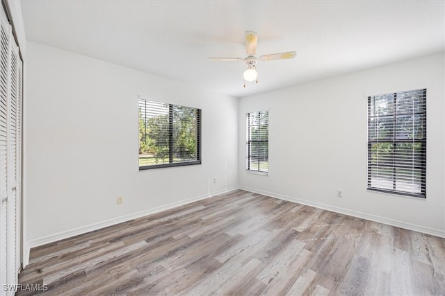 empty room with light hardwood / wood-style flooring and ceiling fan