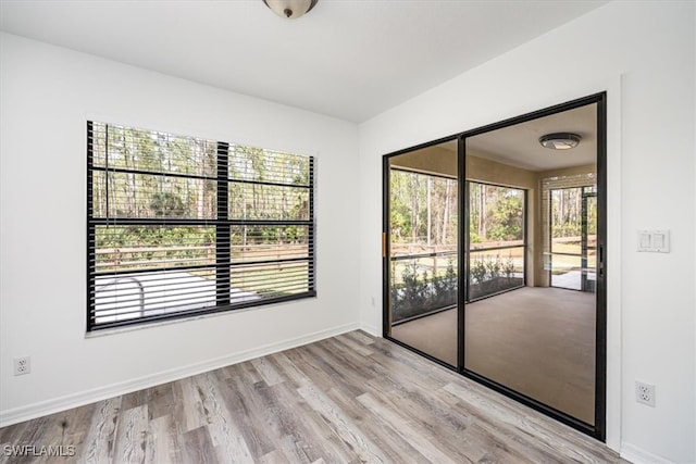 unfurnished room featuring light hardwood / wood-style floors