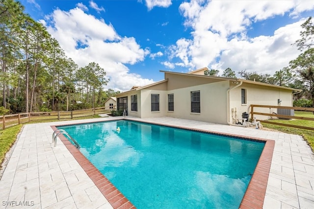 view of pool featuring a patio and a yard