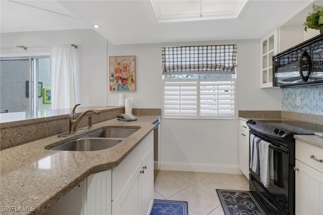 kitchen featuring light stone countertops, sink, black appliances, and white cabinetry