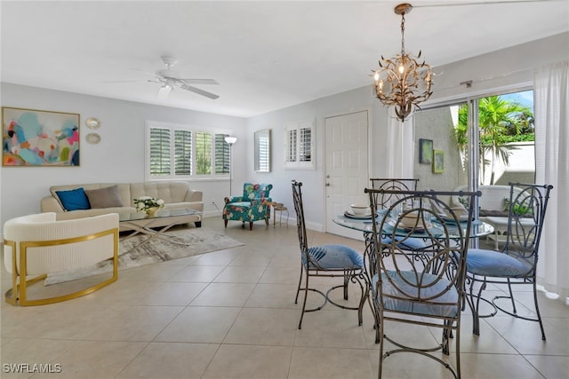 dining space featuring light tile patterned floors and ceiling fan with notable chandelier