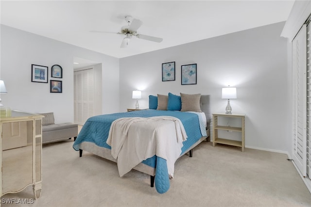 bedroom featuring a closet, ceiling fan, and light colored carpet