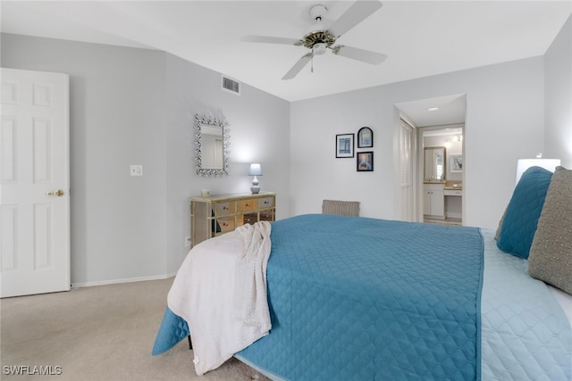 carpeted bedroom with ceiling fan and ensuite bath