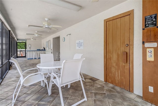 sunroom / solarium featuring ceiling fan