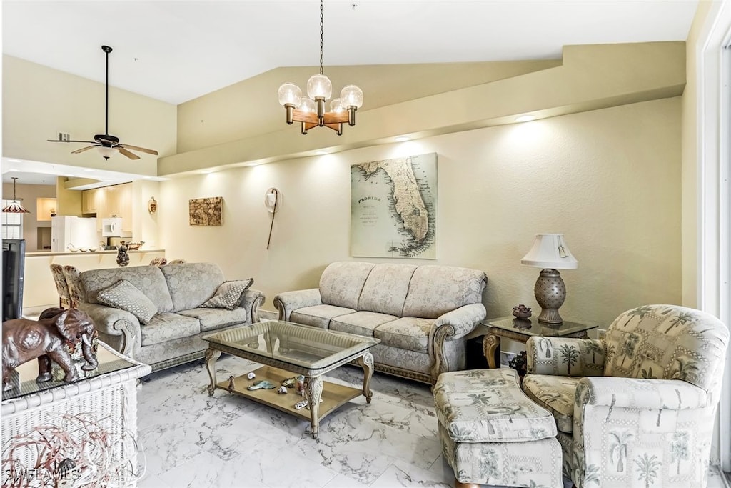 living room with vaulted ceiling and ceiling fan with notable chandelier